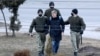 A man is detained in Minsk on March 25, one of at least 170 detained in the capital.