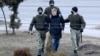 Police detain a man in Minsk on March 25.