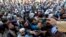 Afghan men wait to collect tokens needed to apply for Pakistan visas in Jalalabad on October 21.