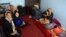 An Afghan family sits in an International Organization for Migration transit center in the western Herat Province after returning from Iran on August 2. 