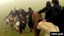 A screenshot from a purported IS video, showing Afghan prisoners being led to their deaths.