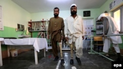 Afghan victims, who lost their limb in landmines blasts, practice with prosthetic limbs, at International Committee of the Red Cross (ICRC) center in Herat on January 31. 