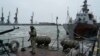 A Ukrainian serviceman stands on board a Coast Guard ship in the Sea of Azov port of Mariupol in eastern Ukraine on December 3.