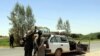 FILE: Afghan soldiers check a vehicle on a road in Helmand's Greshk district.