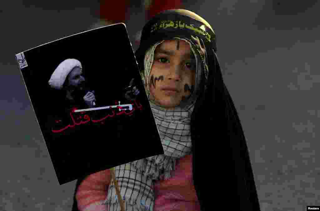 A Shi'ite Muslim girl holds a picture of Shi'ite Muslim cleric Nimr al-Nimr, who was executed in Saudi Arabia, as she takes part in a protest rally in Islamabad, Pakistan. (Reuters/Faisal Mahmood)