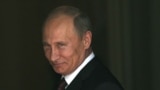 U.K. -- Russian President Vladimir Putin smiles as he walks into 10 Downing Street in London, 02Aug2012