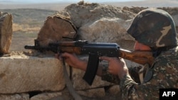 Nagorno-Karabakh -- An Armenian soldier of the self-proclaimed republic of Nagorno-Karabagh aims his assault rifle at the frontline on the border with Azerbaijan, 25Oct2012