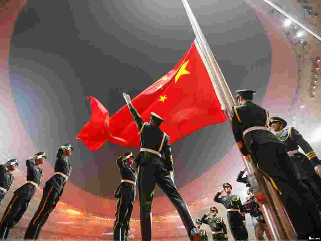 China's national flag is raised during the opening ceremony of the Beijing 2008 Olympic Games at the National Stadium, August 8, 2008. The stadium is also known as the Bird's Nest. REUTERS/Jerry Lampen 