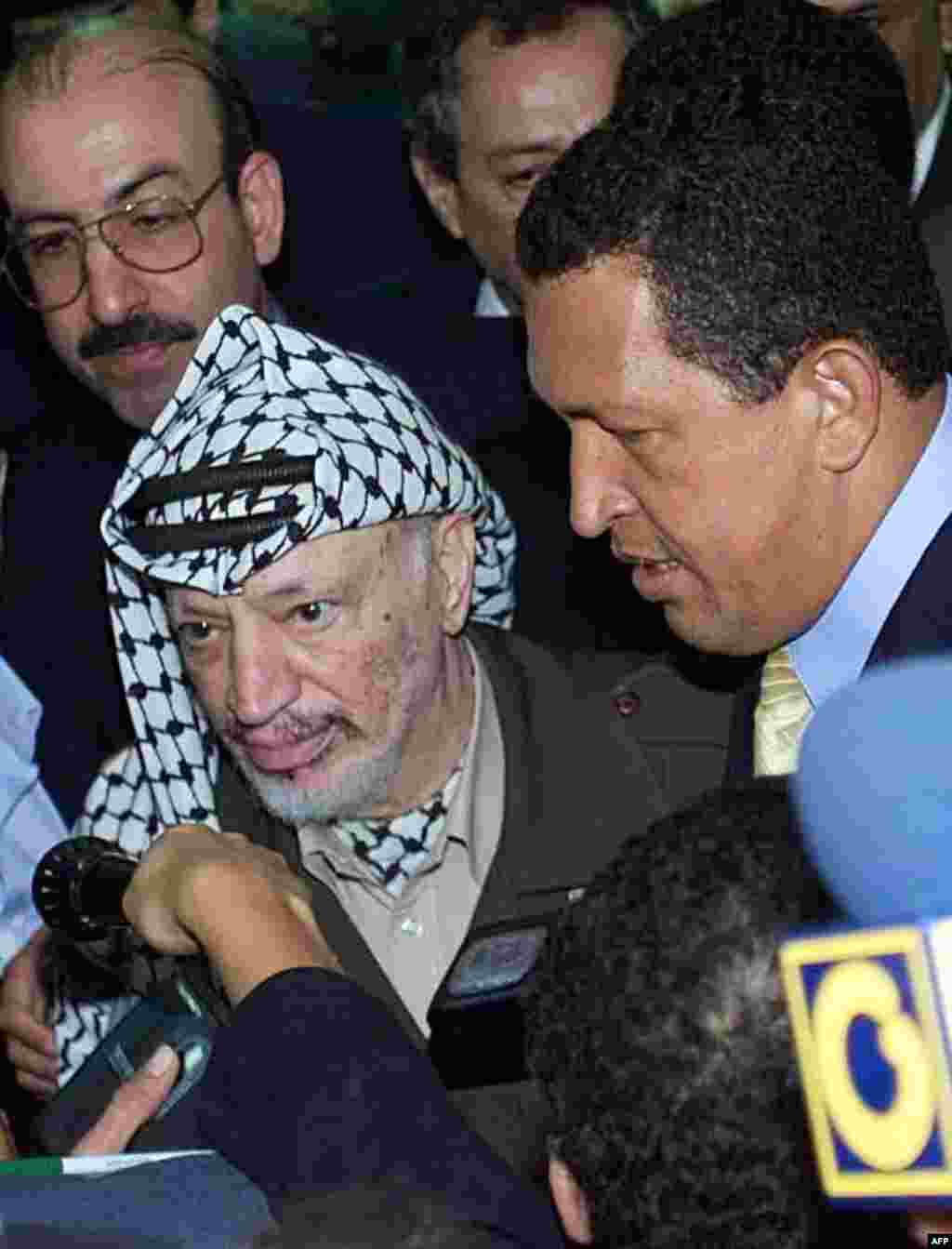 Yaser Arafat (L) President of the Palestinian Authority talks with media beside the Venezuelan President Hugo Chavez at the Convention Center in Havana, 13 April 2000.