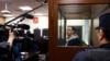 Oleg Roldugin, an investigative journalist for the independent Russian newspaper Novaya Gazeta, stands inside an enclosure for defendants before a court hearing in Moscow on April 10.