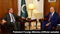 U.S. special envoy Zalmay Khalilzad (R) meets with Pakistani Foreign Minister Shah Mahmud Qureshi, in Islamabad on January 18.