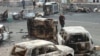 Armenia - A man walks past burned cars on a street in Yerevan where security forces clashed with opposition protesters, 2 March 2008.