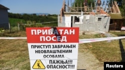 A sign saying "Access forbidden to unauthorized persons" is displayed in front of a house bought by Rio Tinto in Gornje Nedeljice.