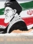 TOPSHOT - A man walks past a mural depicting late Iranian supreme leader Ayatollah Ali Khamenei in Tehran on July 24, 2026.