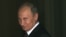 U.K. -- Russian President Vladimir Putin smiles as he walks into 10 Downing Street in London, 02Aug2012
