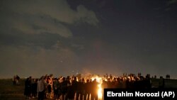 Iranians light fireworks during a celebration, known as &quot;Chaharshanbe Souri,&quot; or Wednesday Feast, marking the eve of the last Wednesday of the solar Persian year, Tuesday, March 19, 2019 in in Tehran, Iran.<br />
&nbsp;