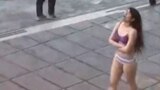 This image grab from a UGC video posted on November 2, 2024 and widely shared on social media, shows a female student in her underwear outside Tehran's Islamic Azad University.