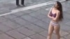 This image grab from a UGC video posted on November 2, 2024 and widely shared on social media, shows a female student in her underwear outside Tehran's Islamic Azad University.