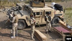 Afghan security forces take positions during an operation against IS militants in Nangarhar Province on November 3.