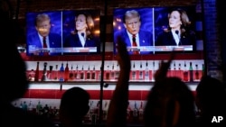 Viewers cheer as they watch a debate between Democratic presidential nominee Vice President Kamala Harris and Republican presidential nominee former President Donald Trump on September 10. 