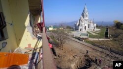 NAGORNO-KARABAKH - Men examine a bomb crater near the Holy Savior Cathedral after shelling by Azerbaijan's forces during a military conflict in Shushi, October 29, 2020