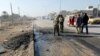 Iraqi security forces stand at the site of a car-bomb attack in the Al-Obaidi neighborhood of Baghdad on January 5.