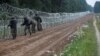 Polish soldiers building a fence on the border between Poland and Belarus near the village of Nomiki on August 26.