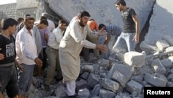 Syria -- Men search for bodies under rubble of a house, destroyed by a government Air force air strike, in a village of Tel Rafat, about 37 km north of Aleppo, 08Aug2012