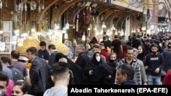 IRAN -- Iranians wearing face masks and protective gloves go shopping ahead of Persian New Year Norouz around the grand bazaar in Tehran, March 18, 2020