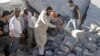 Syria -- Men search for bodies under rubble of a house, destroyed by a government Air force air strike, in a village of Tel Rafat, about 37 km north of Aleppo, 08Aug2012