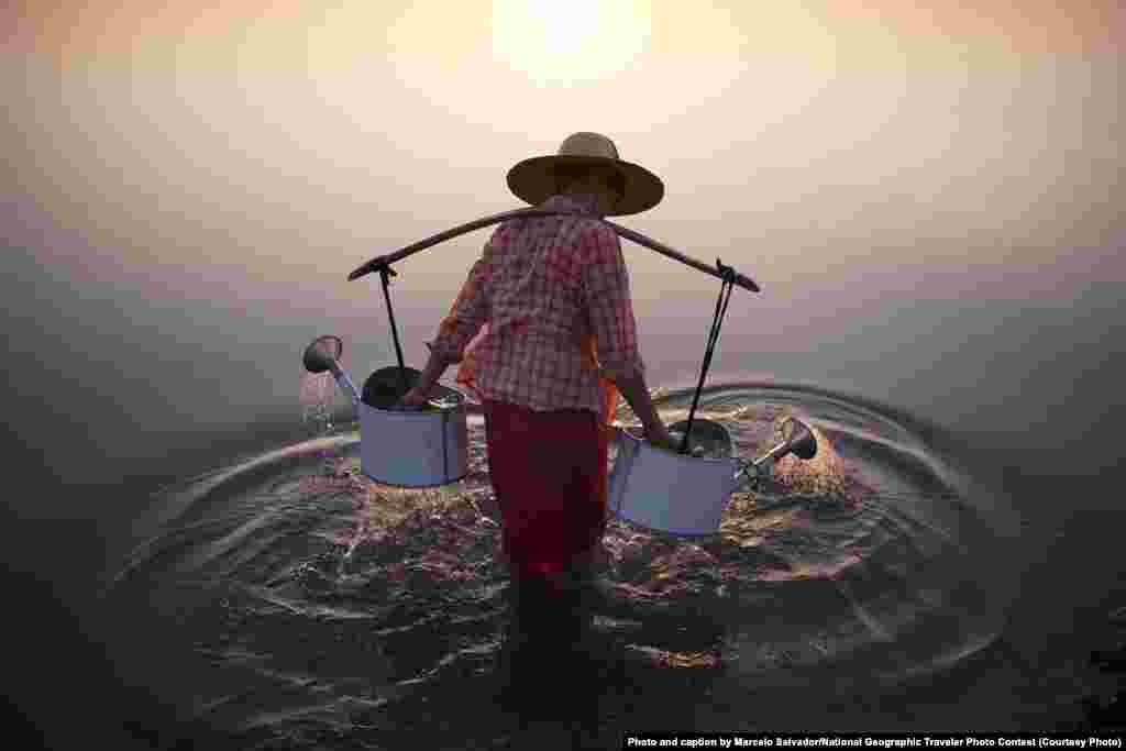 Merit Award: &quot;Lady In Water&quot; by Marcelo Salvador: &quot;A lady collects water in the river by a village in Bagan, Myanmar, 2013.&quot;