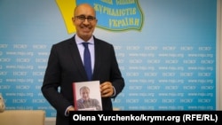 Представник ОБСЄ з питань свободи засобів інформації Арлем Дезір з книжкою кримського журналіста Миколи Семени, березень 2018 року