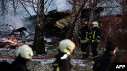 Lithuanian rescuers work next to the wreckage of a cargo plane following its crash near the Vilnius airport on November 25.