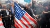 Protesters burn U.S. flag as they take part in an anti-U.S. rally after Friday Prayers to show their support of Iran's revolutionary guards corps (IRGC), in Tehran, April 12, 2019