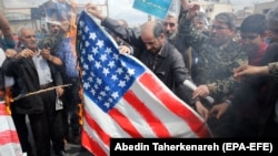 Protesters burn U.S. flag as they take part in an anti-U.S. rally after Friday Prayers to show their support of Iran's revolutionary guards corps (IRGC), in Tehran, April 12, 2019