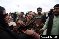 Family members mourn after an attack on Sikh temple in Kabul on March 25, 2020. The attack killed Sikhs and was claimed by the Islamic State militants.