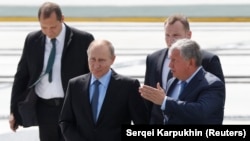 Russian President Vladimir Putin listens to Rosneft Chief Executive Igor Sechin as he visits the Zvezda shipyard in the far eastern town of Bolshoy Kamen, Russia September 8, 2017.