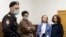 Doxa magazine editors (from left) Armen Aramyan, Natalya Tyshkevich, and Alla Gutnikova wait for a court session in Moscow on April 14, where their "minute of freedom" would be ordered.