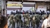 Riot police take up positions during a protest in the northwestern city of Orumieh on August 27.