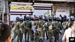 Riot police take up positions during a protest in the northwestern city of Orumieh on August 27.