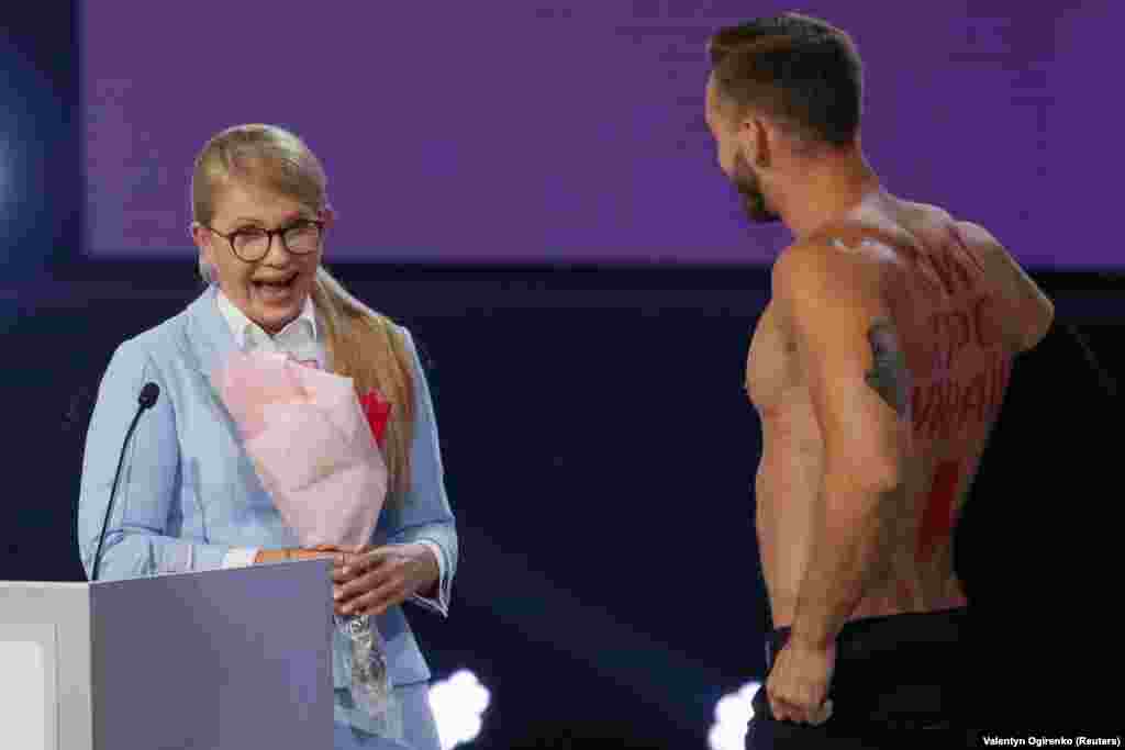 Ukrainian opposition leader Yulia Tymoshenko reacts at the appearance of a man protesting against her new political propositions, as she delivers a speech during a national forum called The New Course of Ukraine, in Kyiv on June 15. (Reuters/Valentyn Ogirenko)