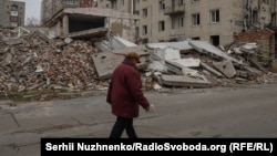 A resident walks along a devastated street in the embattled Ukrainian city of Pokrovsk. 