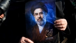 A woman in Tehran on March 9 holds a portrait of Iran's new supreme leader, Mojtaba Khamenei, at a gathering to support his appointment amid the US-Israeli war with Iran.
