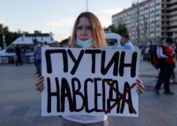 A woman takes part in a protest against the amendments in central Moscow on July 1.