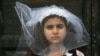 A young actress plays the role of Giorgia, 10, forced to marry Paolo, 47, during an event organized by Amnesty International to denounce child marriage, on October 27, 2016 in Rome. File photo