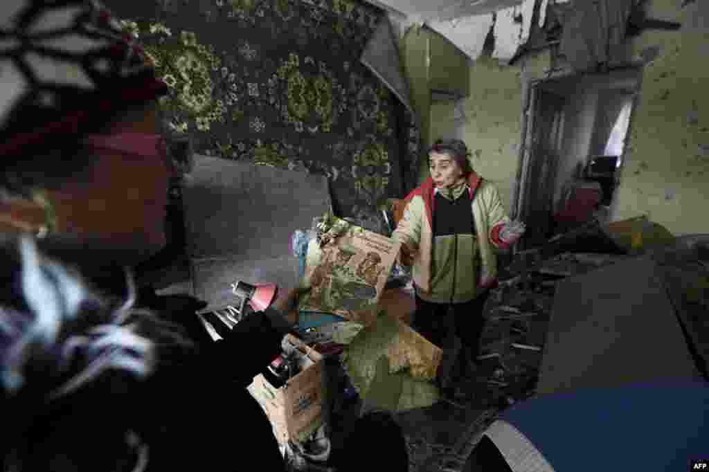 Women survey damage in a flat after it was destroyed by shelling the night before in the Kuibishevskiy district of the eastern Ukrainian city of Donetsk. (AFP/Eric Feferberg)