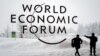 SWITZERLAND -- A security guard show the way to a man outside of the Davos Congress Centre under snow ahead of the opening of the World Economic Forum (WEF) 2018 annual meeting, in Davos, January 22, 2018