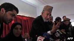 Afghan members of parliament gather in a hotel in Kabul to break the deadlock on whether or not to open the new parliament.