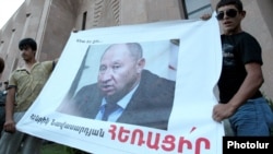 Armenia - Youth activists hold up a banner demanding the resignation of Henrik Navasardian, Yerevan's public transport chief, 28Jul2013 