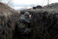 A Ukrainian soldier rests in a trench on the front line with Russia-backed separatists near the village of Krasnohorivka in the Donetsk region in February.